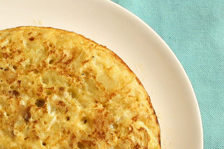 Close-up of a cooked pancake on a white plate.