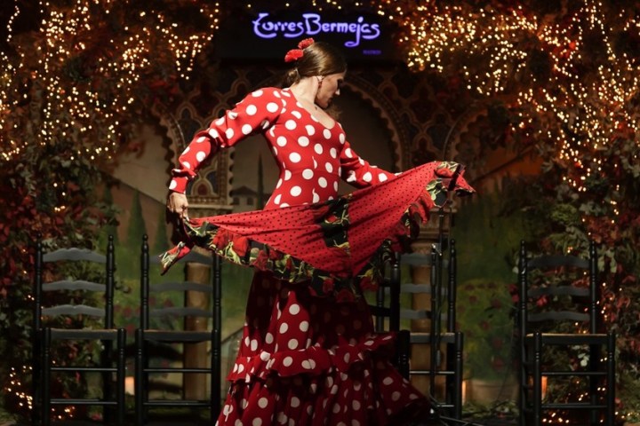 a person standing next to a christmas tree