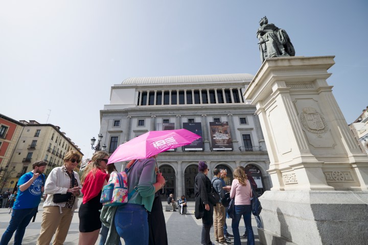a group of people walking in front of a building