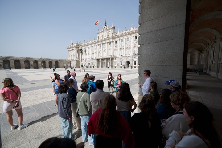 a group of people walking in front of a building