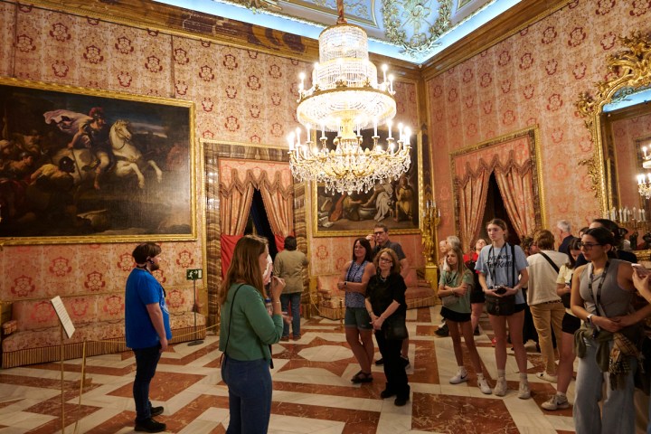 a group of people walking in front of a building