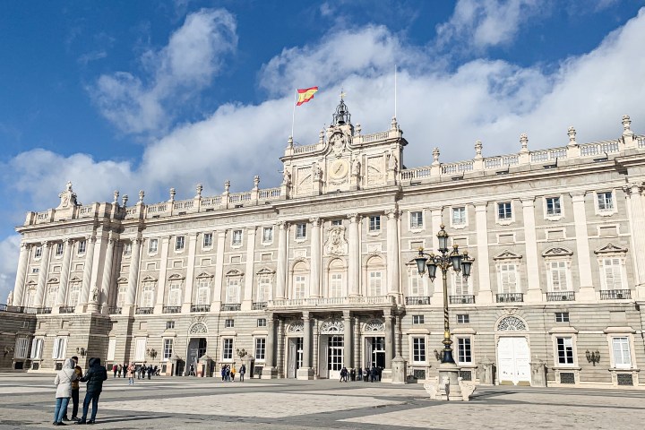 a large building with Royal Palace of Madrid in the background