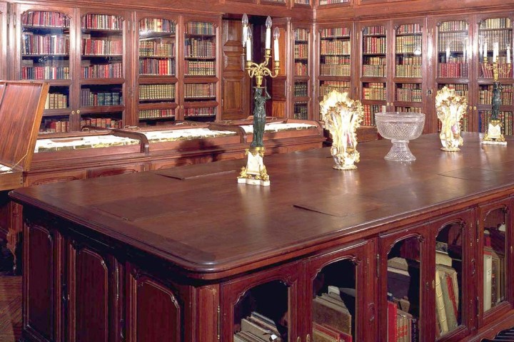 a group of people sitting at a table in a library