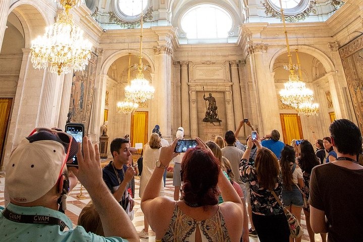 a group of people standing in front of a mirror posing for the camera