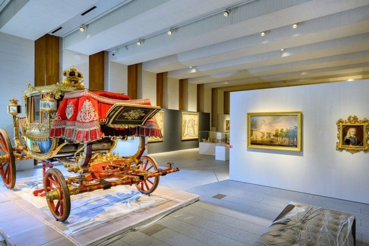 a person riding a horse drawn carriage