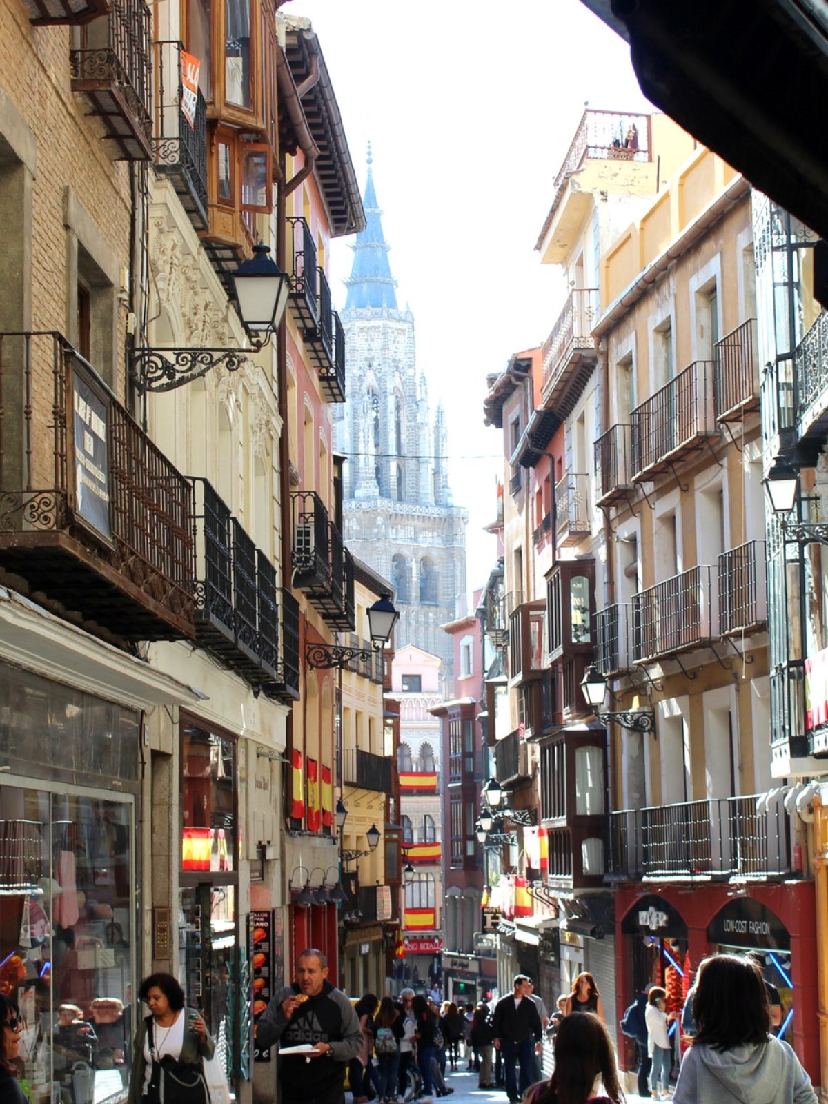 a group of people walking on a city street