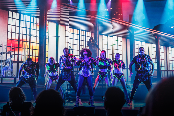 a group of people on a stage in front of a crowd