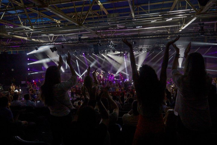 a group of people on a stage in front of a crowd