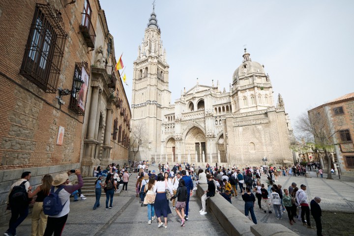 a group of people walking in front of a building