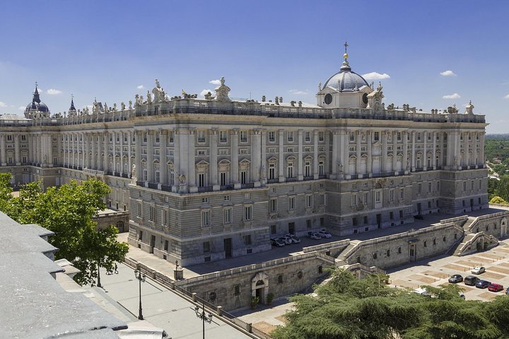 Exterior view of a large, historic palace with ornate architecture and a dome on top.