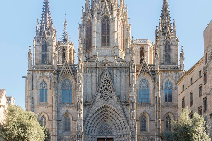 Gothic cathedral with intricate spires and a clear blue sky.